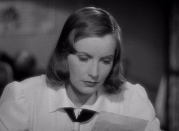 Movie still from “Ninotchka” (1939), directed by Ernst Lubitsch – A black - and - white photo of a woman looking down; Close Up shot, High angle