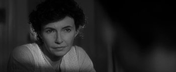 Movie still from “Nixon” (1995), directed by Oliver Stone – Black and white photograph of a woman in a white shirt; Close Up shot, Over the shoulder angle