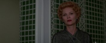 Movie still from “Nixon” (1995), directed by Oliver Stone – A person wearing a suit and tie; Close Up shot, Low angle