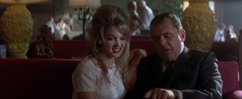 Movie still from “Nixon” (1995), directed by Oliver Stone – A man and a woman sitting at a table in a restaurant; Close Up shot, Over the shoulder angle