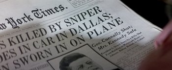 Movie still from “Nixon” (1995), directed by Oliver Stone – Image of a newspaper article; Extreme Close Up shot, Overhead angle