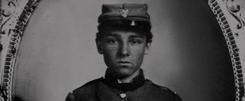 Movie still from “Nixon” (1995), directed by Oliver Stone – An old black and white photo of a man in a uniform; Close Up shot, Overhead angle