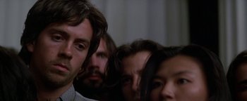 Movie still from “Nixon” (1995), directed by Oliver Stone – A group of people standing next to each other in a room; Close Up shot, Low angle