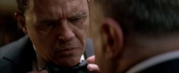 Movie still from “Nixon” (1995), directed by Oliver Stone – An older man looking into a mirror while a younger man looks at him; Close Up shot, Over the shoulder angle