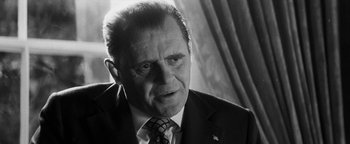 Movie still from “Nixon” (1995), directed by Oliver Stone – Black and white photograph of an older man in a suit; Close Up shot, Low angle
