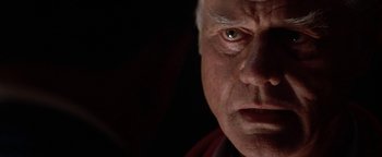 Movie still from “Nixon” (1995), directed by Oliver Stone – An older man with a serious look on his face; Close Up shot, Low angle