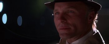 Movie still from “Nixon” (1995), directed by Oliver Stone – A person wearing a hat; Close Up shot, Low angle