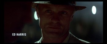 Movie still from “Nixon” (1995), directed by Oliver Stone – A person wearing a hat; Close Up shot, Over the shoulder angle