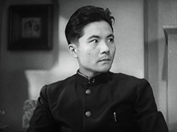 Movie still from “No Regrets for Our Youth” (1946), directed by Akira Kurosawa – An old photo of a man in a suit looking to his left; Close Up shot, Low angle