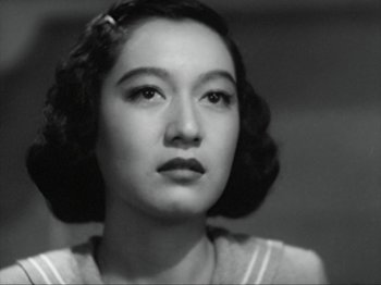 Movie still from “No Regrets for Our Youth” (1946), directed by Akira Kurosawa – An old black and white photo of a woman looking at the camera; Close Up shot, Low angle