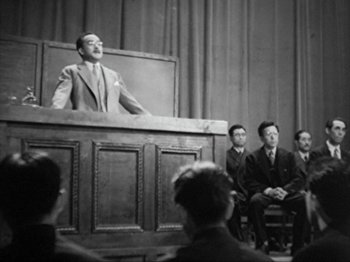 Movie still from “No Regrets for Our Youth” (1946), directed by Akira Kurosawa – An old photo of a man speaking in front of a crowd; Wide shot, Low angle