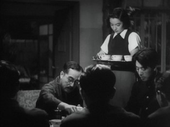 Movie still from “No Regrets for Our Youth” (1946), directed by Akira Kurosawa – A group of people sitting around a table; Medium shot, Over the shoulder angle