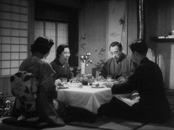 Movie still from “No Regrets for Our Youth” (1946), directed by Akira Kurosawa – A group of people sitting around a table; Medium shot, High angle