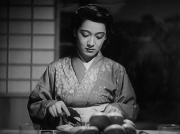 Movie still from “No Regrets for Our Youth” (1946), directed by Akira Kurosawa – An old photo of a woman cutting apples; Medium shot, Low angle