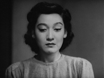 Movie still from “No Regrets for Our Youth” (1946), directed by Akira Kurosawa – An old photo of a woman in a sweater looking to her left; Close Up shot, High angle