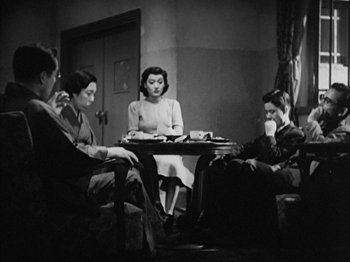 Movie still from “No Regrets for Our Youth” (1946), directed by Akira Kurosawa – A group of people sitting around a table; Medium shot, High angle