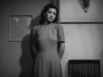 Movie still from “No Regrets for Our Youth” (1946), directed by Akira Kurosawa – A woman standing in front of a wall in a room; Medium shot, Low angle