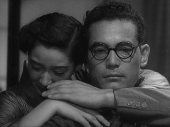 Movie still from “No Regrets for Our Youth” (1946), directed by Akira Kurosawa – A man and a woman sitting next to each other; Close Up shot, Low angle