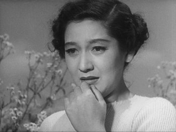Movie still from “No Regrets for Our Youth” (1946), directed by Akira Kurosawa – An old black and white photo of a woman with her hand on her chin; Close Up shot, High angle