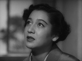 Movie still from “No Regrets for Our Youth” (1946), directed by Akira Kurosawa – An old black and white photo of a woman looking to her left; Close Up shot, Low angle