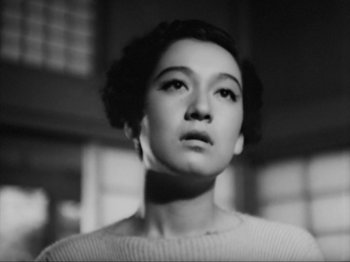 Movie still from “No Regrets for Our Youth” (1946), directed by Akira Kurosawa – A black - and - white photo of a woman looking at the camera; Close Up shot, Low angle