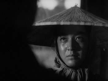 Movie still from “No Regrets for Our Youth” (1946), directed by Akira Kurosawa – A person wearing a hat and looking into the distance; Close Up shot, Over the shoulder angle