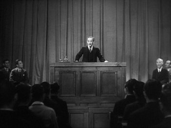 Movie still from “No Regrets for Our Youth” (1946), directed by Akira Kurosawa – An old photo of a man giving a speech to an audience; Wide shot, Low angle