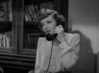 Movie still from “No Time for Love” (1943), directed by Mitchell Leisen – A black and white photo of a woman talking on a phone; Close Up shot, Low angle