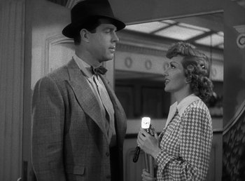 Movie still from “No Time for Love” (1943), directed by Mitchell Leisen – A man and a woman are talking to each other; Medium shot, Low angle