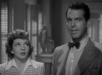 Movie still from “No Time for Love” (1943), directed by Mitchell Leisen – A man and a woman standing next to each other in a room; Close Up shot, Low angle