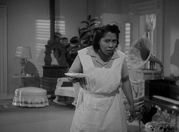 Movie still from “No Time for Love” (1943), directed by Mitchell Leisen – A woman holding a plate in a room; Medium shot, High angle