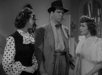 Movie still from “No Time for Love” (1943), directed by Mitchell Leisen – Two women and a man standing next to each other in a room; Medium shot, Over the shoulder angle