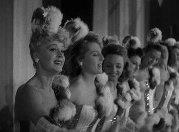 Movie still from “No Time for Love” (1943), directed by Mitchell Leisen – A group of women standing next to each other; Close Up shot, Low angle