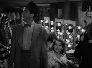 Movie still from “No Time for Love” (1943), directed by Mitchell Leisen – A man and a woman in front of a mirror; Medium shot, Low angle