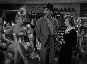 Movie still from “No Time for Love” (1943), directed by Mitchell Leisen – Two women and a man in a dress shop; Medium shot, Over the shoulder angle
