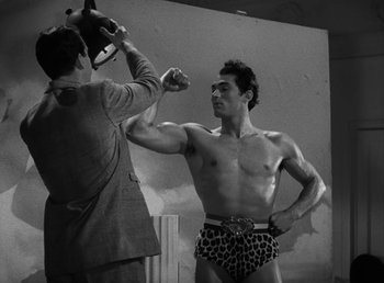 Movie still from “No Time for Love” (1943), directed by Mitchell Leisen – A black and white photo of a man in a leopard print underwear; Medium shot, Low angle