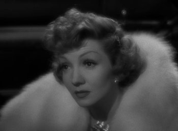 Movie still from “No Time for Love” (1943), directed by Mitchell Leisen – An old photo of a woman in a fur coat; Close Up shot, High angle