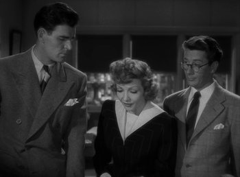 Movie still from “No Time for Love” (1943), directed by Mitchell Leisen – A woman and two men standing next to each other in a room; Medium shot, High angle