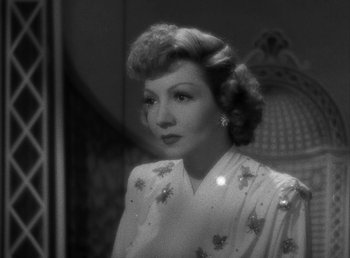 Movie still from “No Time for Love” (1943), directed by Mitchell Leisen – An old photo of a woman in a white dress; Close Up shot, Low angle