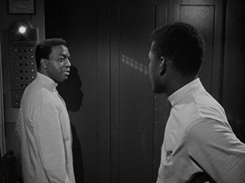 Movie still from “No Way Out” (1950), directed by Joseph L. Mankiewicz – A black and white photo of two men talking; Medium shot, Over the shoulder angle