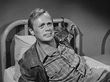 Movie still from “No Way Out” (1950), directed by Joseph L. Mankiewicz – A man sitting in a bed with a cell phone in his hand; Close Up shot, High angle