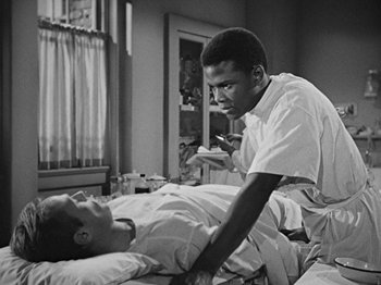 Movie still from “No Way Out” (1950), directed by Joseph L. Mankiewicz – An older man and a younger man in a hospital bed; Medium shot, Over the shoulder angle