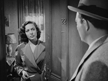 Movie still from “No Way Out” (1950), directed by Joseph L. Mankiewicz – An old photo of a man and a woman looking at each other; Medium shot, Over the shoulder angle