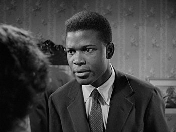 Movie still from “No Way Out” (1950), directed by Joseph L. Mankiewicz – A black and white photo of a man in a suit and tie; Close Up shot, Low angle