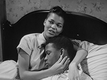 Movie still from “No Way Out” (1950), directed by Joseph L. Mankiewicz – A man and a woman laying in a bed together; Medium shot, High angle