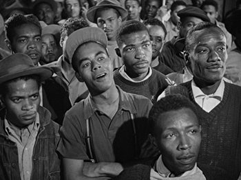 Movie still from “No Way Out” (1950), directed by Joseph L. Mankiewicz – Black and white photograph of a group of men; Medium shot, High angle