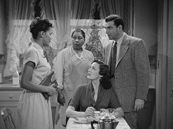 Movie still from “No Way Out” (1950), directed by Joseph L. Mankiewicz – A group of people standing around a table; Medium shot, Over the shoulder angle