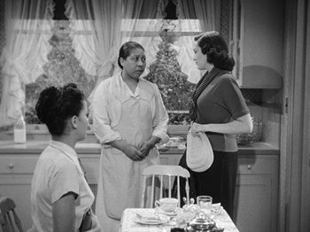 Movie still from “No Way Out” (1950), directed by Joseph L. Mankiewicz – A group of women standing around a table; Medium shot, Over the shoulder angle