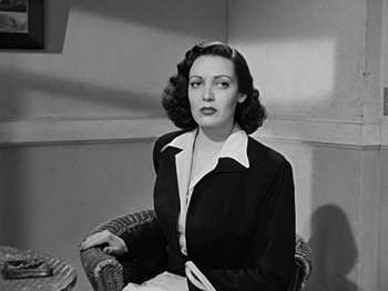 Movie still from “No Way Out” (1950), directed by Joseph L. Mankiewicz – A woman sitting in a chair in front of a window; Medium shot, Low angle