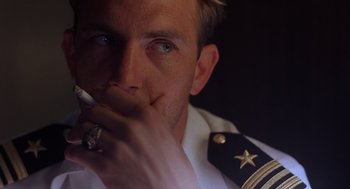 Movie still from “No Way Out” (1987), directed by Roger Donaldson – A person holding a cell phone; Close Up shot, Over the shoulder angle